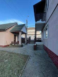 a house with a balcony and a patio at Річкова Поляна in Polyana
