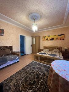a large room with two beds and a rug at Річкова Поляна in Polyana