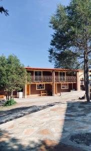 a large building with trees in front of it at Cabañas las Gemelas in Areponapuchi