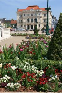 a garden of flowers in front of a building at Donaupark Camping Tulln in Tulln