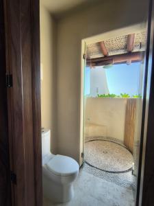 a bathroom with a toilet and a shower at Oceanfront Designer Penthouse, Private Pool in Ixtapa
