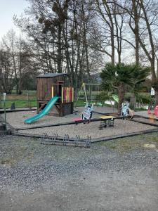 a park with a playground with a slide and swings at Nuit insolite in Beaufay