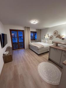 a large bedroom with a bed and a desk at Alpenglück in Immenstadt im Allgäu