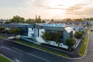an aerial view of a building with a parking lot at Hamilton Motel in Hamilton