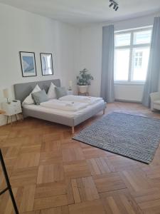 a living room with a bed and a rug at Innsbruck Residence in Innsbruck