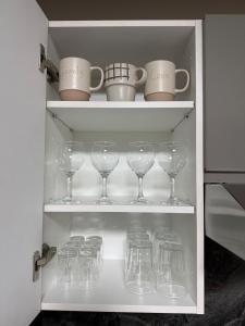 a cupboard filled with lots of wine glasses at Studio luxueux avec vue panoramique sur le centre ville in Fez +12 photos