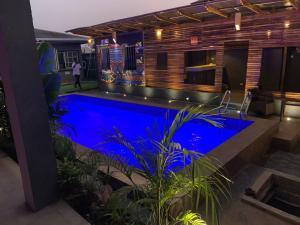 a swimming pool in the middle of a house at Exodus Hotel & Restaurant in Aiyetoro