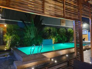 a swimming pool in the middle of a house at Exodus Hotel & Restaurant in Aiyetoro