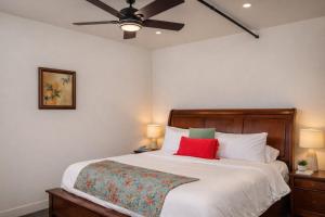 a bedroom with a large white bed with red pillows at Downtown Appleton Condo 2 Bedroom Loft Sleeps 6 in Appleton