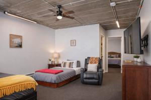 a bedroom with a bed and a ceiling fan at Downtown Appleton Condo 2 Bedroom Loft Sleeps 6 in Appleton +7 photos