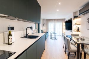 a kitchen with a sink and a counter top at Geysotur Ribera Luxury Suites in Córdoba