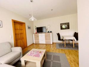 a living room with a couch and a table at Ferienwohnung Shar Pei in Thiessow