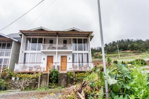 a house on the side of a hill at Altura Cabin Dieng in Diyeng
