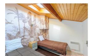 a room with two beds and a mural on the wall at maisonnette bord de mer in Royan