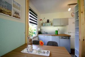 a kitchen with a table with a vase on it at Neu Süllitz, Bungalow 50 in Neu Süllitz