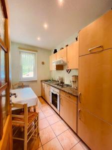 a kitchen with a table and a large refrigerator at Ferienwohnung Bobtail in Thiessow
