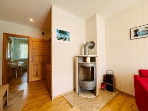 a living room with a red couch and a television at Ferienwohnung Bobtail in Thiessow
