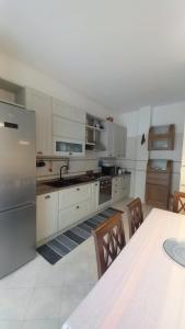 a kitchen with white appliances and a table and chairs at Al Centro - Gaeta in Gaeta