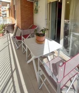 a white table and chairs on a patio at Al Centro - Gaeta in Gaeta