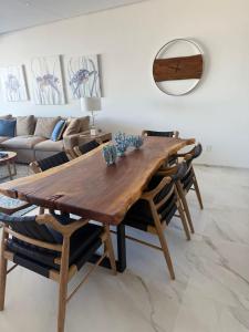 a dining room with a wooden table and chairs at New Golf Course Condo with Ocean Views in San José del Cabo