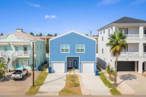a blue house in front of some houses at Steps to Beach Private Pool 2 Big Levels in South Padre Island