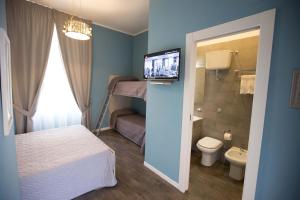 a bedroom with a bed and a bathroom with a toilet at Luxury B&B La Spelunca in Santa Maria Capua Vetere +59 photos