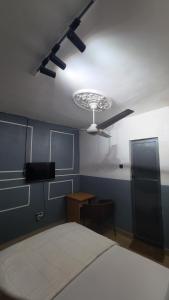 a bedroom with a bed and a ceiling fan at Exodus Hotel & Restaurant in Aiyetoro