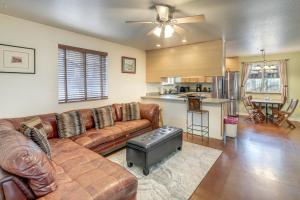 a living room with a couch and a kitchen at Explore the Coconino Forest! Flagstaff Cottage in Flagstaff