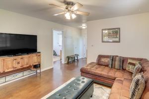 a living room with a couch and a flat screen tv at Explore the Coconino Forest! Flagstaff Cottage in Flagstaff