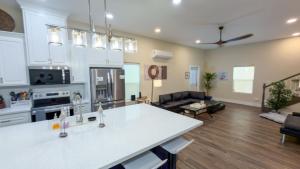 a kitchen and living room with a white counter top at Steps to Beach Private Pool 2 Big Levels in South Padre Island