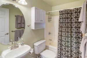 a bathroom with a sink and a toilet and a mirror at Explore the Coconino Forest! Flagstaff Cottage in Flagstaff +19 photos