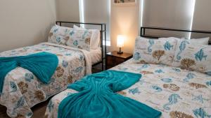 two beds sitting next to each other in a bedroom at Steps to Beach Private Pool 2 Big Levels in South Padre Island +90 photos