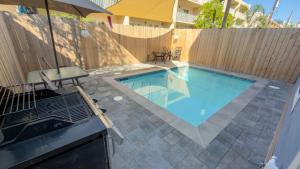 a swimming pool in front of a wooden fence at Steps to Beach Private Pool 2 Big Levels in South Padre Island