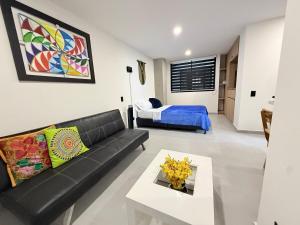 a living room with a black couch and a bed at New studio, exceptional location with parking in Santa Rosa de Cabal +50 photos