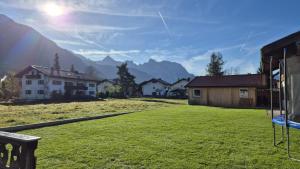 a view of a yard with houses and a swing at Das Alpenglühn Hotel & Restaurant in Krün