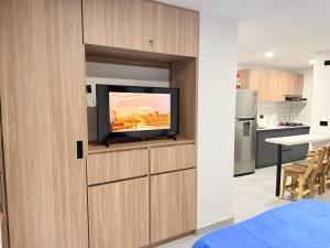 a living room with a tv on a wall at New studio, exceptional location with parking in Santa Rosa de Cabal