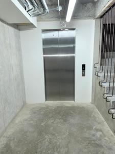 an empty room with a metal elevator in a building at New studio, exceptional location with parking in Santa Rosa de Cabal
