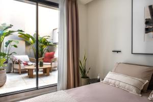 a bedroom with a bed and a view of a living room at Casa Marella in Balestrate