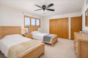 a bedroom with two beds and a ceiling fan at East Side 3 Br 2 full bath King Bed in Appleton