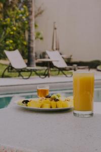 a plate of fruit on a table with a glass of orange juice at Santa Maria del Cabo in San José del Cabo