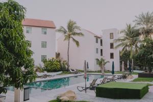 a view of a hotel with a pool and palm trees at Santa Maria del Cabo in San José del Cabo