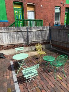 a patio with tables and chairs and a fence at Luxe in the Lou in Saint Louis