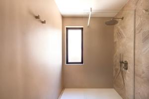 a bathroom with a shower and a window at Casa Marella in Balestrate