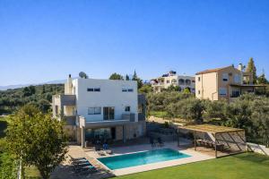 an aerial view of a house with a swimming pool at Villa Aelia - Modern & Ideal for large groups in Galatás +37 photos
