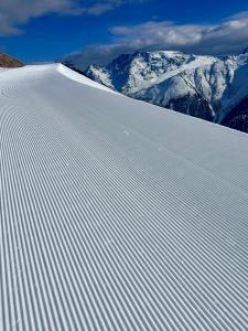a snow covered slope with mountains in the background at Apart Jil-Marie Studio 7 in Samnaun +18 photos