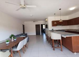 a kitchen and living room with a table and chairs at Condo Sunset in Cabo San Lucas