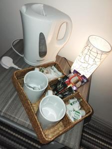 a tray with a tea pot and bowls on a table at The Commodore Hotel in Nottingham
