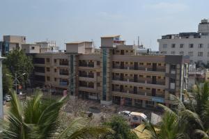 an apartment building in the middle of a city at Hotel Sai Vishwa in Shirdi