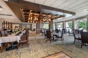 a dining room with tables and chairs and windows at Heidel House Hotel and Conference Center, an Ascend Collection Hotel in Green Lake
