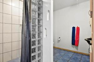 a bathroom with a shower with glass blocks on the wall at JB380-Fjerritslev-Gottrupvej-311-C in Fjerritslev +11 photos